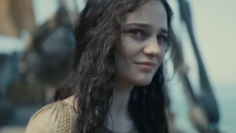 a young brunette girl smiling on a ship