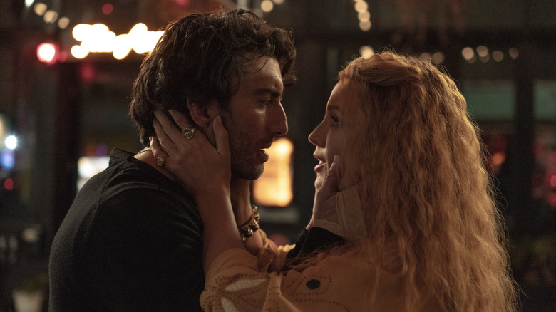 Blake Lively's Lily holding the neck of Justin Baldoni's Ryle as they look into each other's eyes in It Ends With Us