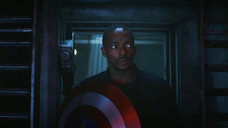 Anthony Mackie as Sam Wilson holding his shield as he enter's The Leader's hideout in Captain America: Brave New World