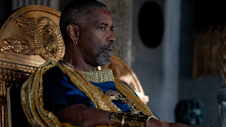 Denzel Washington as Marcrinus looking out on the battle in the arena in Gladiator II