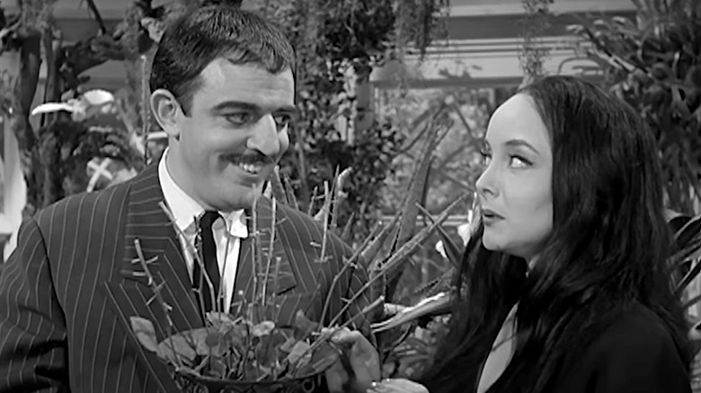 John Astin and Carolyn Jones stare at a freshly cut bouquet of dead roses on The Addams Family