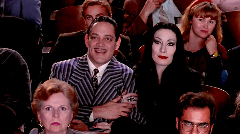 Raul Julia and Anjelica Huston watch Wednesday and Pugsley perform in the school play in The Addams Family