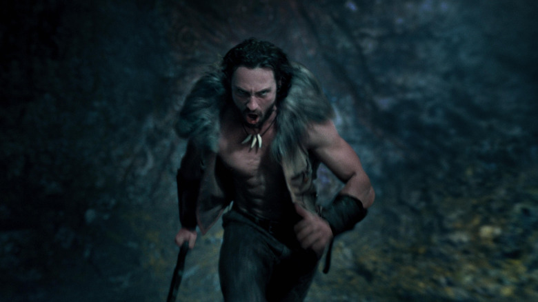 Aaron Taylor-Johnson as Kraven running through a cave in his full costume in Kraven the Hunter