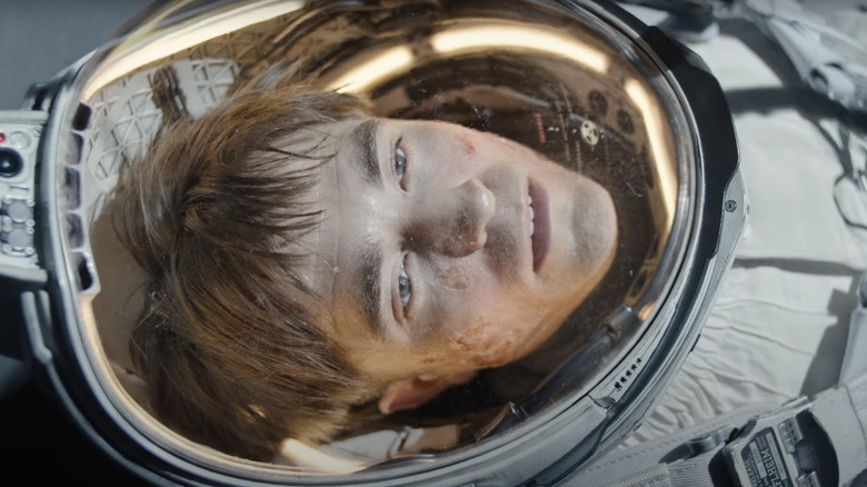 Robert Pattinson's Mickey laying in his space suit in Mickey 17