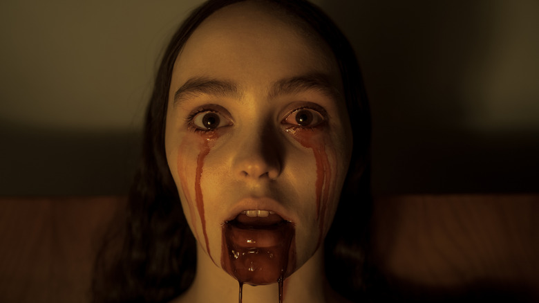 Lily-Rose Depp as Ellen Hutter with her bleeding eyes and mouth in Nosferatu (2024)