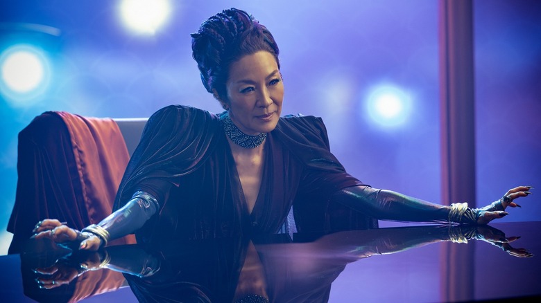 Empress Georgiou sitting at a table with her arms spread in Star Trek: Section 31