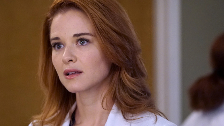 April Kepner looking surprised in her white coat on Grey's Anatomy