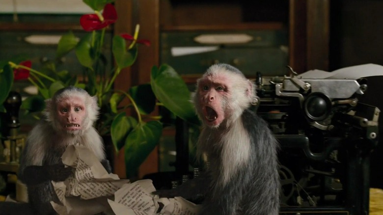 Doctor Dolittle's monkeys looking surprised while using the typewriter in Dolittle