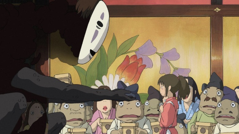 No Face tries to give Chihiro a gift.