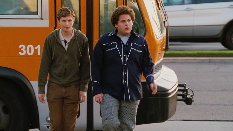 Michael Cera and Jonah Hill getting off an orange bus