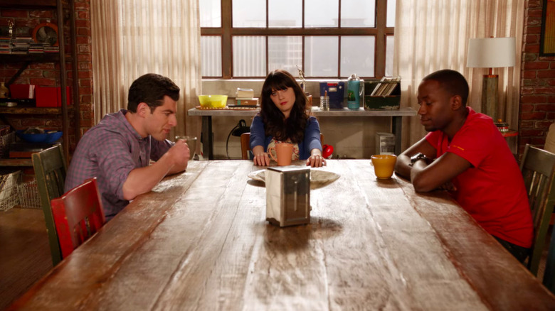 Jess, Winston, and Schmidt sit at the table in New Girl