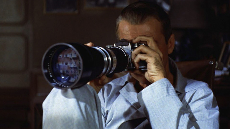 L.B. Jeffries looking through a long camera lens in Rear Window