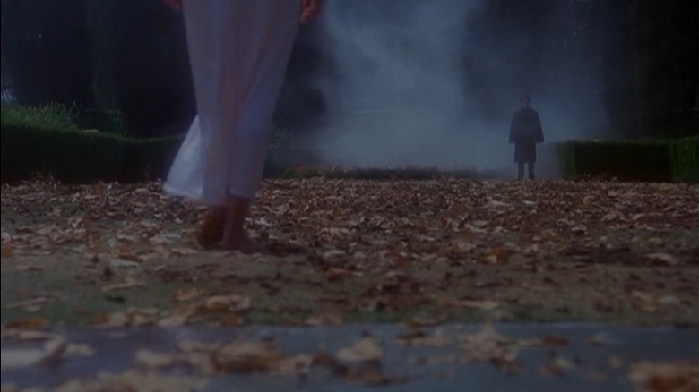 Woman walking towards fog-covered man in Dark Shadows