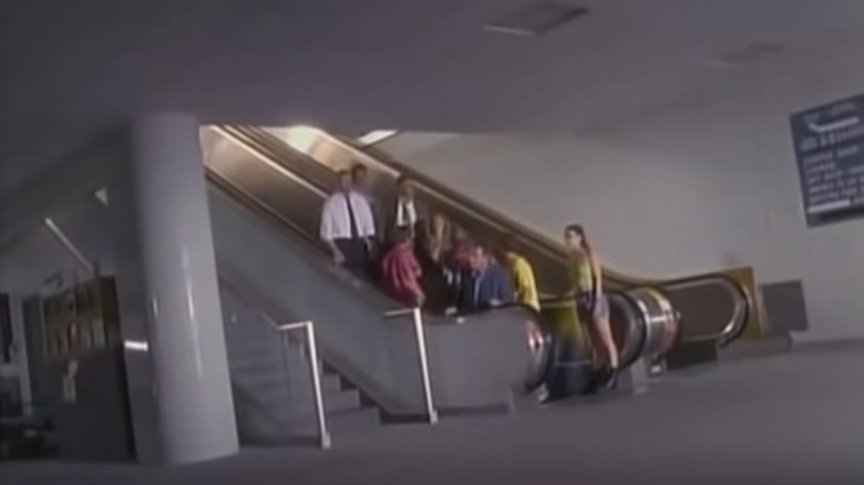 People gathered on escalator in empty airport in Langoliers