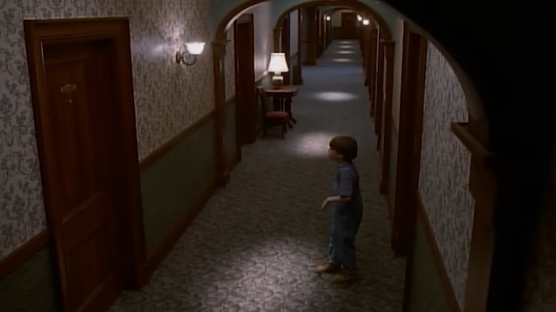 Danny Torrance standing in an Overlook corridor in The Shining miniseries