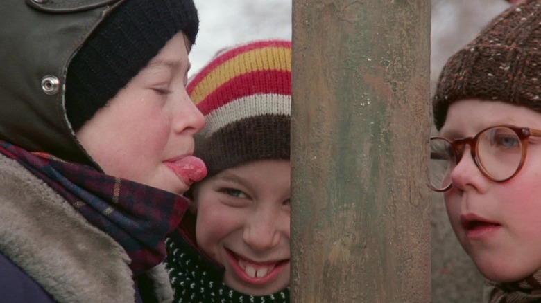 A kid's tongue out near frozen pole