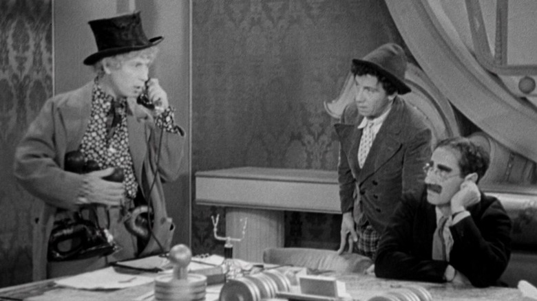 Groucho, Harpo and Chico at a desk