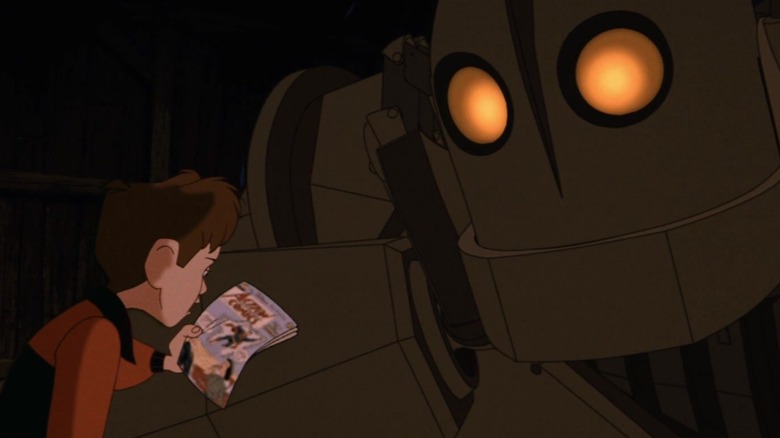 Boy reads comic book to giant war machine