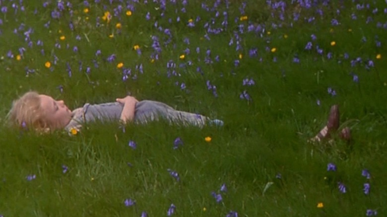 Girl lays in flowery field