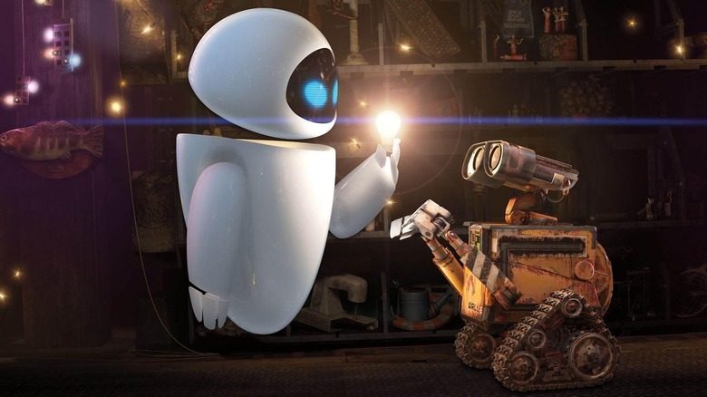 Eve holding lightbulb up to WALL-E