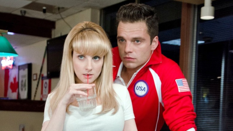 Melissa Rauch as Hope standing with Sebastian Stan as Lance in The Bronze