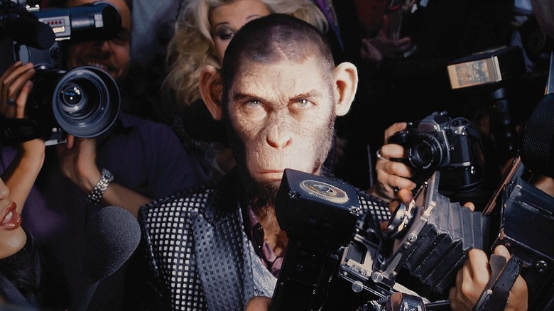 Robbie Williams as an ape surrounded by the media in Better Man