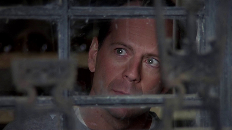 Dr. Malcolm Crowe looking through an old barred window in The Sixth Sense