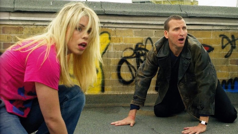 Rose Tyler and the 9th Doctor looking shocked on Doctor Who