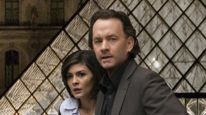 Robert Langdon and Sophie Neveu looking tense in front of the Louvre