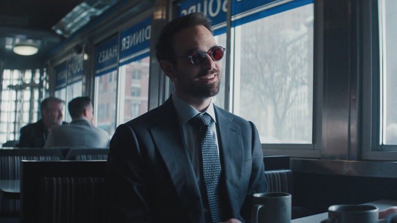 Matt Murdock suited up and sitting in a diner booth in Daredevil: Born Again