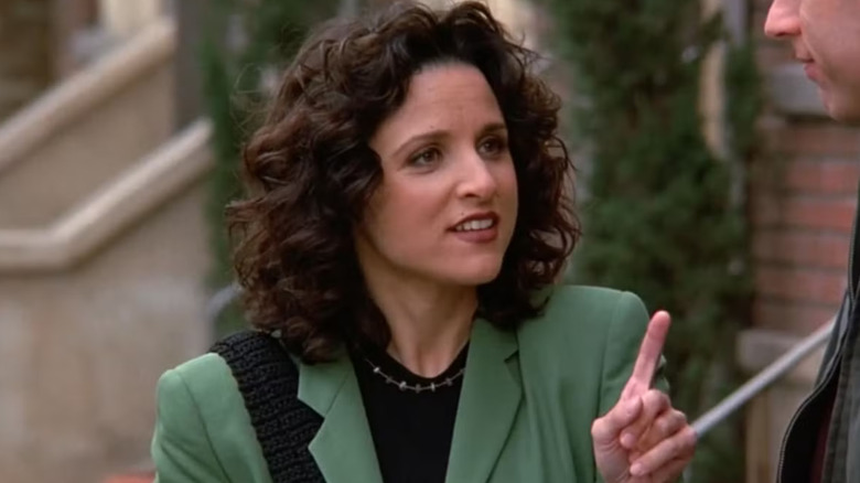 Julia Louis-Dreyfus as Elaine Benes on Seinfeld pointing