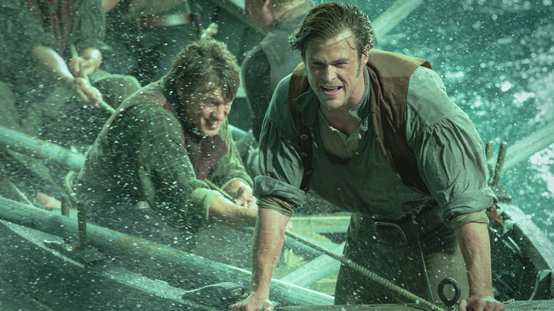 Chris Hemsworth como Owen Chase aguenta durante uma tempestade durante In the Heart of the Sea