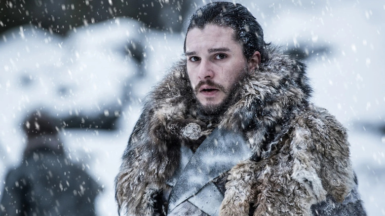 Kit Harington as Jon Snow, standing in the snow, getting snowed on, in Game of Thrones