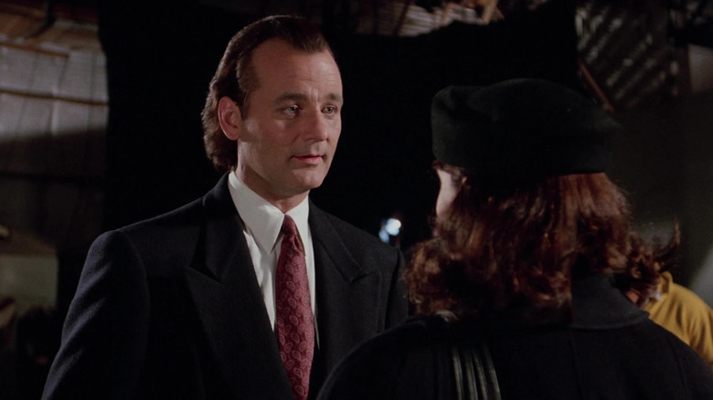 Frank Cross, looking smug, talking to his soon-to-be-ex-girlfrien in Scrooged.