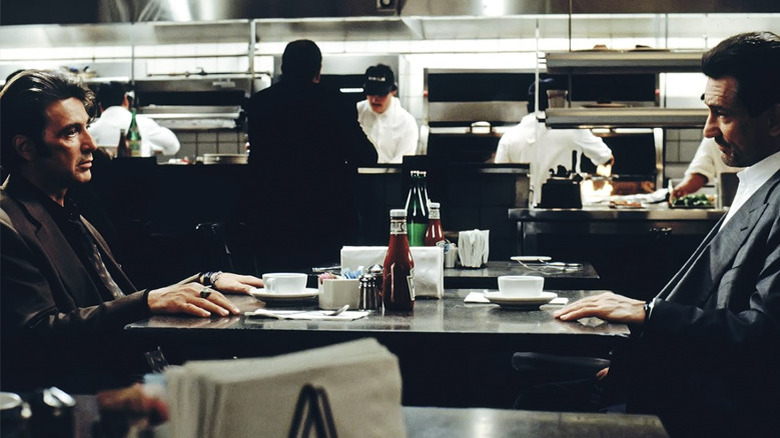 Vincent Hanna and Neil McCauley sit opposite each other at a diner table in Heat