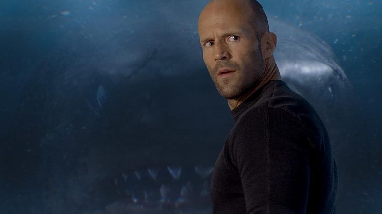 Jason Statham as Jonas standing in front of the megalodon in The Meg