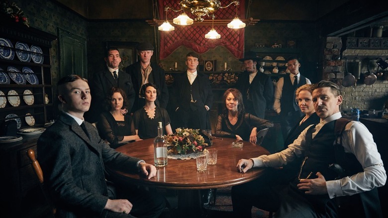 Cillian Murphy as Tommy, Paul Anderson as Arthur, Kate Phillips as Linda, and the rest of the Shelby family gathered around a table in Peaky Blinders