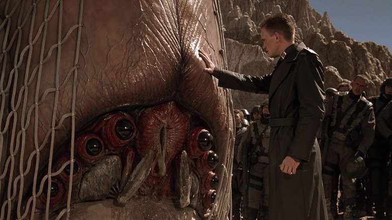 Carl, putting his hand on the Smart Bug's gelatinous head, looking for signs of fear in Starship Troopers