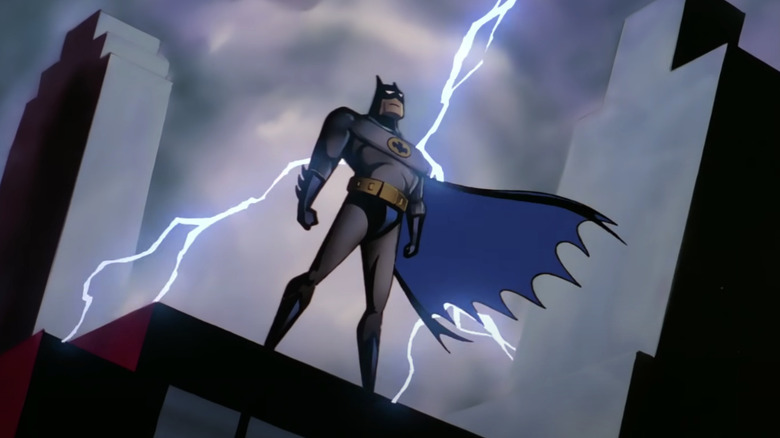 Batman poses while lightning strikes behind him in Batman: The Animated Series