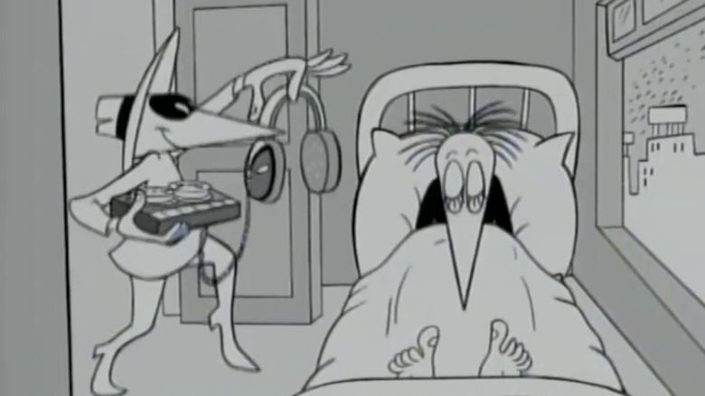 The white spy prepares to place headphones on the head of a sleeping black spy in Spy vs. Spy on Mad TV