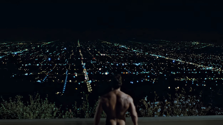 Arnold Schwarzenegger's Terminator stands looking out over Los Angeles at night in The Terminator