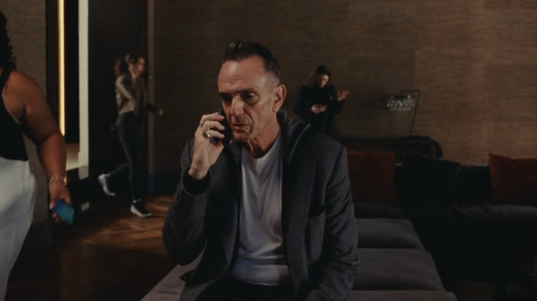 Hank Azaria Shayim sits while talking on the phone in the idol