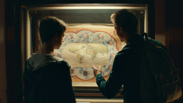 Young Nathan and Sam Drake inspect a map in Uncharted