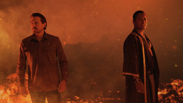 Cuba Gooding Jr. as Balthazar and Josh Burdett at Gabriel standing in a fiery location in Angels Fallen: Warriors of Peace