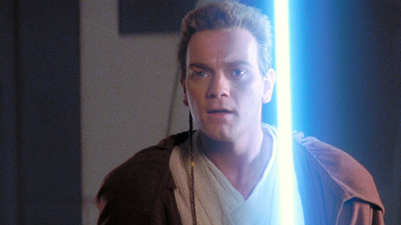 Obi-Wan Kenobi brandishes his blue lightsaber in Star Wars Episode I: The Phantom Menace