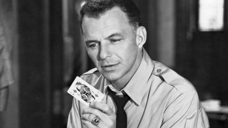 Ben Marco holds a Queen of Diamonds in The Manchurian Candidate