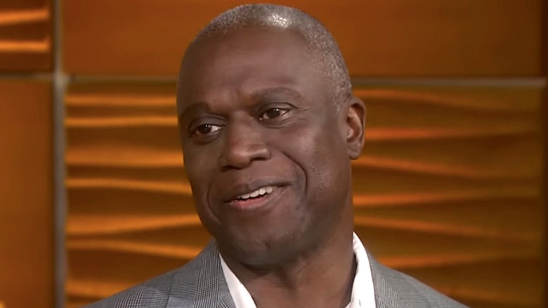 Andre Braugher in TV studio interview grey suit