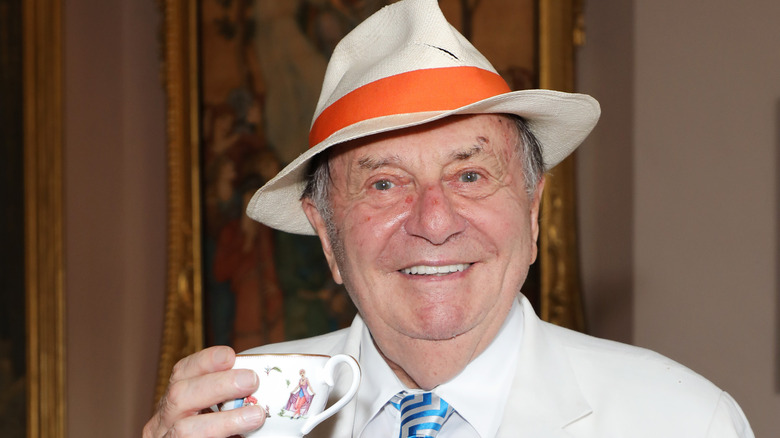 Barry Humphries holding a drink