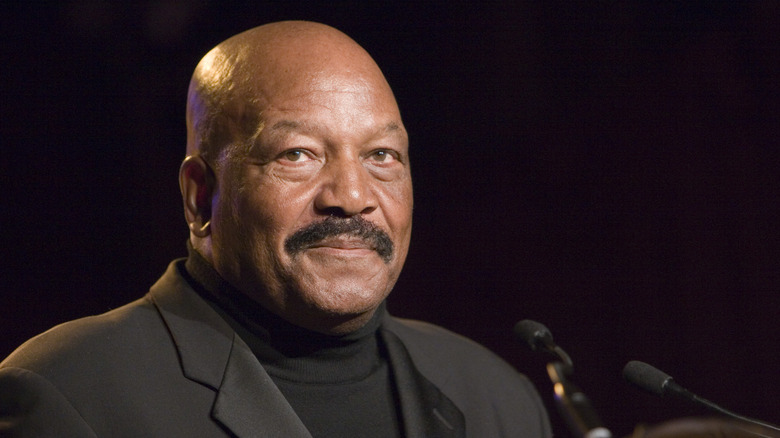 Jim Brown speaks at a podium