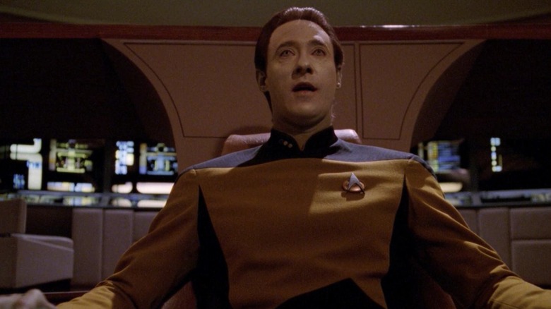 Data, sitting in the captain's chair of the Enterprise on an episode of Star Trek: The Next Generation.